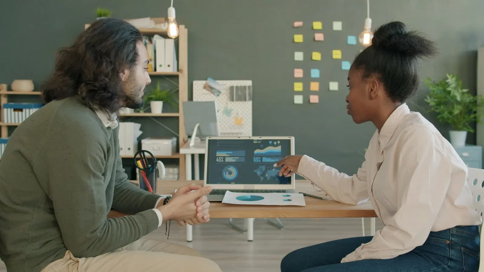 Two colleagues going through a demo on a laptop